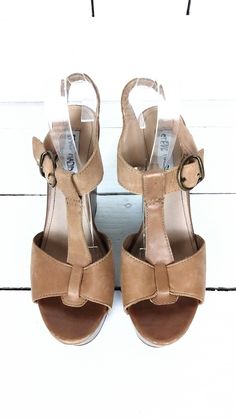 "Steve Madden open toe platform wedge sandal/t strap sandals/high heel wedge leather sandals/9 Measurements... - marked size: 9 - insole length: 10\" -width at ball: 3\" -heel: 5\" -front platform: 1.75\" Features... -genuine leather -high platform -adjustable strap -Steve Madden Condition... -great leather condition -minor scuffing on leather -minor wear on the soles and platform 1I3220*" Vintage Leather T-strap Sandals With Open Toe, Vintage Leather T-strap Open Toe Sandals, Vintage Open Toe T-strap Sandals For Summer, Summer T-strap Sandals With 4-inch Heel, Summer T-strap Heels With 4-inch Heel, Brown Open Toe Wedge Sandals, Summer T-strap Wedge Sandals, Brown T-strap Wedge Sandals For Summer, Spring Platform T-strap Heels