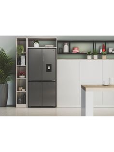 a refrigerator freezer sitting inside of a kitchen next to a table and potted plants