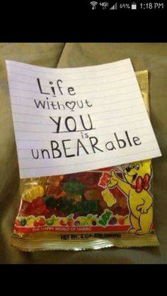 a bag of gummy bears sitting on top of a bed next to a note that says life without you unbearable