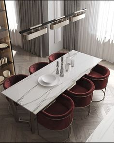 a dining room table with six chairs and a white marble slab top on the center