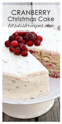 a cake with white frosting and cranberries on top