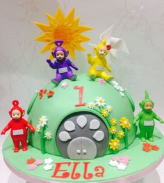 a birthday cake decorated with figurines and decorations