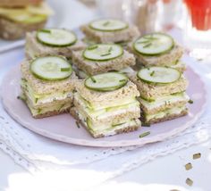 cucumber sandwiches are arranged on a plate