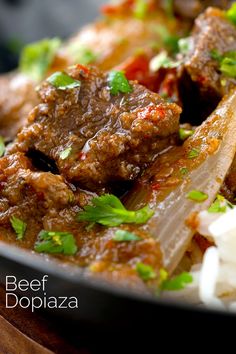 a close up of a plate of food with meat and onions