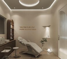 a white chair in a room with lights on the ceiling and a potted plant next to it