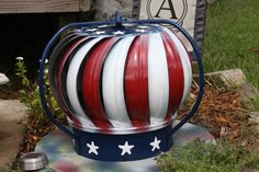 a red, white and blue ball with stars on it is sitting in the grass