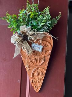 a heart shaped planter hanging on a door