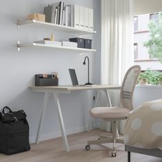 a room with a desk, chair and bookshelf