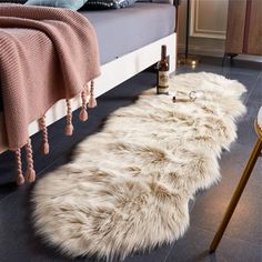 a white sheepskin rug sitting on top of a bed