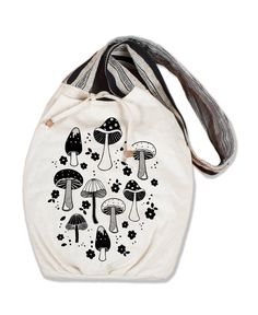 This adorable Shrooms & Blooms Canvas Boho Bag is ideal for a magical summer journey. Bring with you as you venture to the ocean, forest, or an outdoor concert. Roomy and spacious, drop your favorite things inside with its heavy cotton canvas and inside pocket. Fully lined with a striped strap and tie closure – wooden bead is attached to each tie string. This hobo bag features a front image of mushrooms and flowers for extra groovy vibes! 15 x 5 x 16 inches with a 40.5 inch strap. Natural. Fabric & Care: 100% Cotton Made in Nepal Woven canvas fabric Fabric weight of canvas outside: 10.22 oz/sq yd Fabric weight of striped lining fabric: 11.28 oz/sq yd Hand wash. Line dry. Ocean Forest, Mushroom Images, Groovy Vibes, Outdoor Concert, Gardening Outfit, Eco Friendly Clothing, Coin Bag, Novelty Items, Boho Bag