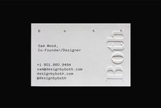 a white business card sitting on top of a black table