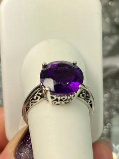 Natural Purple Amethyst Solid Sterling Silver RingK Design#D4 This is a brand-new Victorian design in solid sterling silver. The beautiful trellis filigree of the 5-carat ring is crafted in an amazing vintage style. This full cut sparkling gemstone is 13mm (approximately 1/2") in diameter. The inside of the band is marked 925 for sterling silver. It is a ring that will be treasured as an heirloom. Notice the beautifully intricate design of the silver filigree setting and trellis band. This allur Elegant Amethyst Crystal Ring With Prong Setting, Elegant Amethyst Round Cut Ring For Gift, Elegant Amethyst Ring Gift, Round Cut, Purple Amethyst Ring With Intricate Design, Elegant Round Cut Amethyst Ring Gift, Elegant Formal Amethyst Crystal Ring, Elegant Amethyst Crystal Ring Round Cut, Elegant Round Amethyst Gemstone Ring, Exquisite Round Amethyst Ring For Anniversary