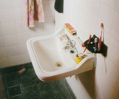 a bathroom with a sink, mirror and towel rack