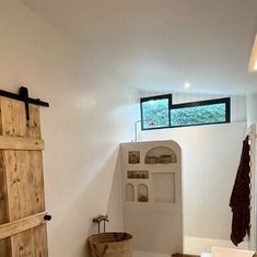 a bathroom with white walls and wooden doors