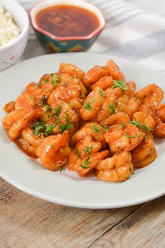 a white plate topped with shrimp covered in sauce