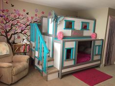 a child's bedroom with bunk bed and stairs to the top floor, decorated in pink and blue