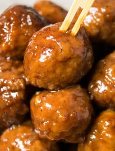 the meatballs are covered in sauce and have toothpicks sticking out of them