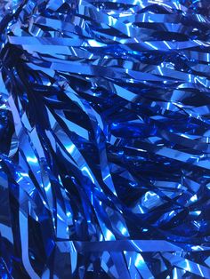 shiny blue streamers in the shape of an abstract pattern on a black background photo