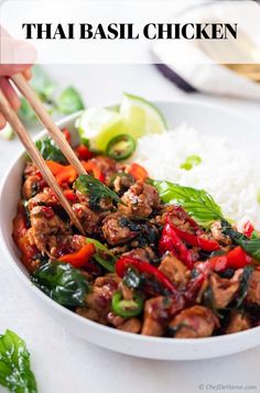 a white bowl filled with meat and veggies on top of rice next to chopsticks