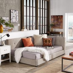 a living room filled with furniture and lots of windows