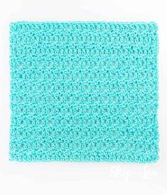 the crocheted dishcloth is blue and has small holes at the bottom that make it appear to be made from yarn