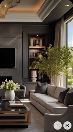 a living room filled with furniture and a flat screen tv mounted on the wall next to a window