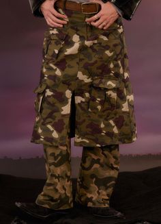 Urban Camo Cargo Trousers by KADAKADA feature a unique camouflage dinosaur print, perfect for a bold streetwear look. These trousers include 3 front flap pockets, zipper closure, classic belt loops, and a double-layer slit skirt design. Made from a durable Terylene, Rayon, Cotton, and Nylon blend, they are available in Army Green. Ideal for both men and women, these wide-fit trousers run small, so consider sizing up. Size Chart: Size (CM) Length Waist Hips Small 106 74 98 Medium 108 78 100 Large Classic Belt, Angel Dress, Fitted Trousers, Cargo Trousers, Skirt Design, Dinosaur Print, Military Fashion, Womens Maxi Dresses, Skirt Pants