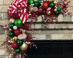 a fireplace decorated with christmas ornaments and candy canes in front of a brick fire place