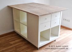 an empty room with a white cabinet and wooden floor