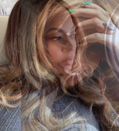 a woman with long hair sitting in a car