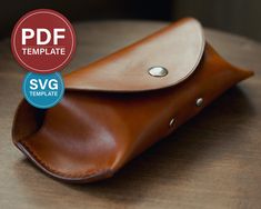 a brown leather case sitting on top of a wooden table