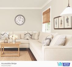 a living room filled with furniture and a large clock on the wall above it's windows