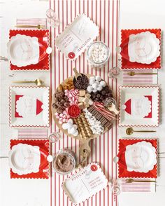 a table set for christmas with candy, candies and other holiday treats on it