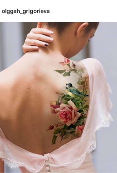 the back of a woman's shoulder with flowers on it