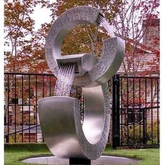 a large metal sculpture in the middle of a park