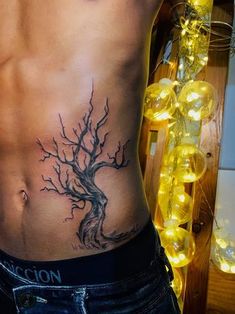 a man with a tree tattoo on his stomach