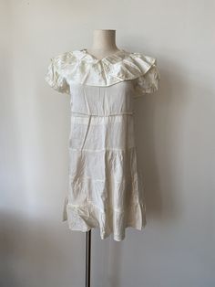 Satin Child's Dress Or Underdress Drop Waist 1930's Cream color. Large collar. Snap closure at shoulder. No stains or tears. Belt loops. Shoulders-13'' Pit to pit-17'' Length-34'' Waist-16.5 flat Vintage Cream Mini Dress With Ruffles, Vintage White Ruffled Mini Dress, Vintage White Mini Dress With Ruffles, Fitted Cream Vintage Mini Dress, Vintage Cream Mini Dress, Vintage White Ruffles Dress For Daywear, Vintage White Dress With Ruffles For Daywear, Cream Retro Vintage Dress With Short Sleeves, Vintage Cream Mini Dress With Short Sleeves