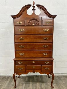 an old wooden dresser sitting on top of a hard wood floor