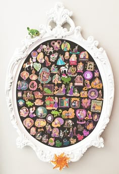 an ornate white frame with many stickers on it