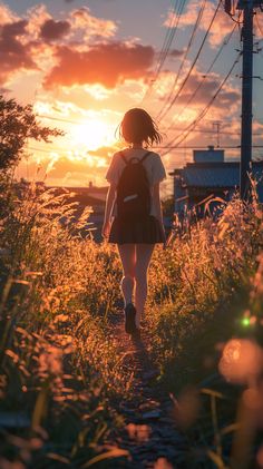 a girl walking down a path at sunset