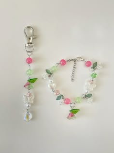 a necklace and bracelet made out of glass beads with charms attached to the clasps