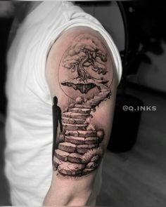 a man with a tree and stairs tattoo on his arm