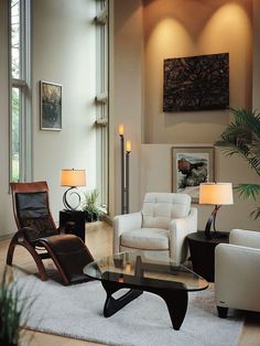 a living room filled with white furniture and lots of windows on the side of it