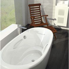 a white bath tub sitting next to a wooden chair