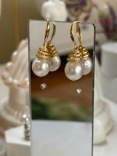 Welcome to PearlologyBoutique! Featuring large 9-10mm, lustrous white south sea pearls set in a gold-tone s925 hook design. Each pearl is topped with a cap adorned with multiple rows of small, sparkling cz stones, adding a touch of luxury and sparkle to the overall look. The hooks are simple and sleek, allowing the pearls and cz stones details to stand out. These earrings are perfect for special occasions or adding a refined touch to any outfit. 💛Pearl Type: White South Sea pearl 💛Pearl Size: Elegant High Luster Pearl Earrings Gift, Elegant Gold Akoya Pearl Earrings, Luxury White Pearl Gold-plated Earrings, Luxury Gold Plated White Pearl Earrings, Gold High Luster Pearl Earrings, Luxury White Gold Plated Pearl Earrings, Gold Pearl Earrings With High Luster For Gift, Luxury Gold Pearl Earrings With Pearl Charm, Luxury Gold Pearl Earrings With Charm