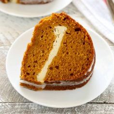 there is a slice of cake on the plate and another piece has been cut in half