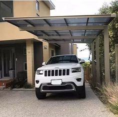 a white jeep parked in front of a house