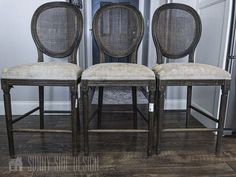 two chairs sitting next to each other on top of a wooden floor in front of a door