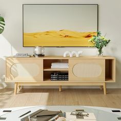 a living room with a painting on the wall and a coffee table in front of it