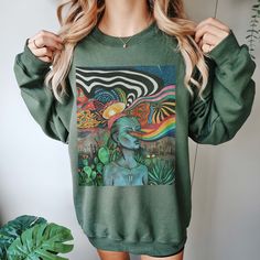 Warm up your pineal gland and keep it properly trippy with a dope new alien sweatshirt. Guaranteed to garner compliments everywhere you go AND it keeps you warm. Win/win! Premium T-shirts are available here: https://chaoticgoodthings.etsy.com/listing/1318650554/vision-quest-trippy-shirt-psychedelic 🌎 MADE TO ORDER, NEVER MASS PRODUCED 🌍 If this is up your alley then be sure to go check out my shop for more goodies: chaoticgoodthings.etsy.com No fast fashion here: These shirts are soft medium w Trippy Shirt Designs, Trippy Designs For Shirts, Clothes Gender Neutral, Hippie Printed Crew Neck T-shirt, Trippy Hoodies, Alien Sweatshirt, Trippy Shirts, 2024 Clothes, Vision Quest